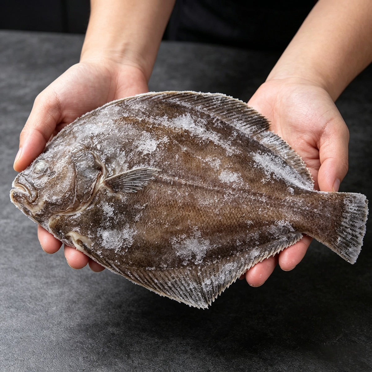 Halibut body portion plated on ice with fresh garnish